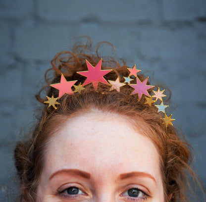 Close-up of a woman wearing the star headband on her curly red hair
