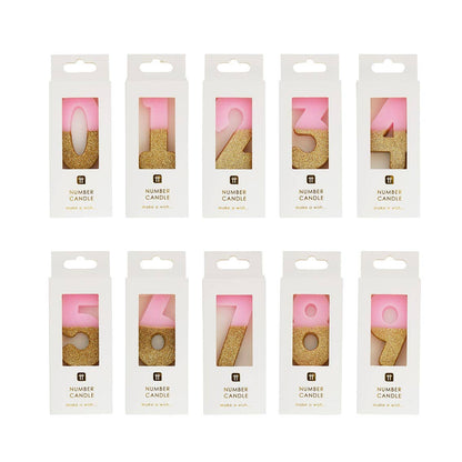 Ten boxed pink and gold glitter number candles in a row, 0 to 9