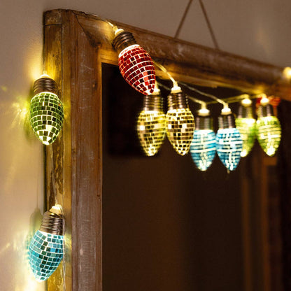 String of lit disco bulbs in green, yellow and blue draped around a wooden frame